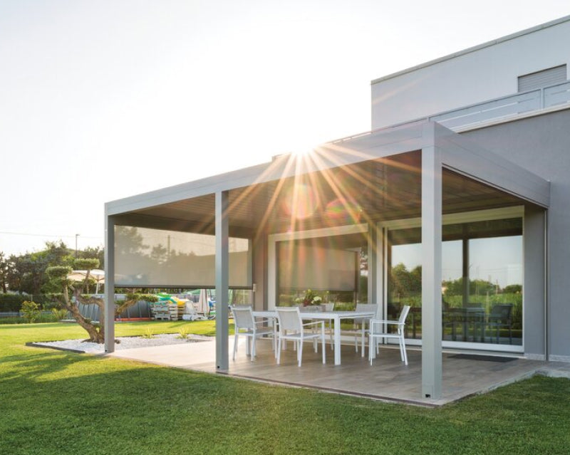 Modern aluminum pergola with louvered roof and outdoor dining set on a sunny patio