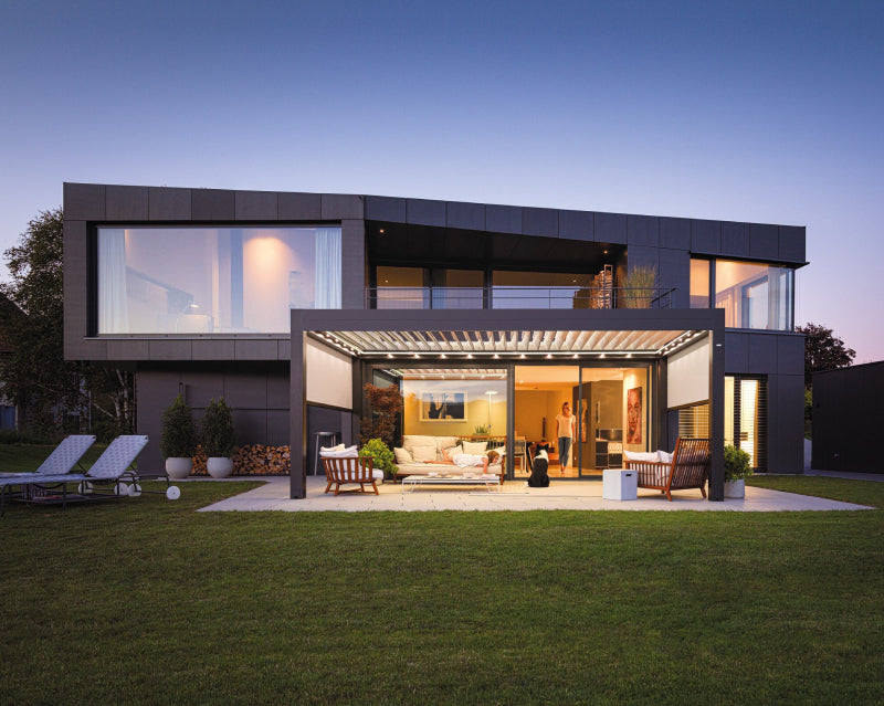 family home with outdoor pergola at dusk 