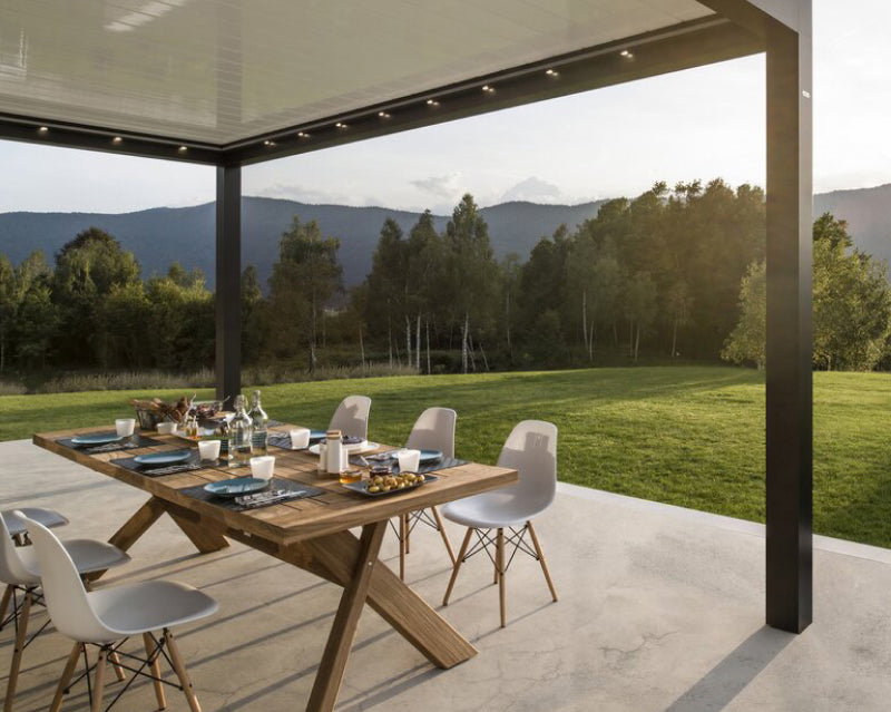 Luxury outdoor pergola with modern aluminium frame, dining set, and scenic garden view