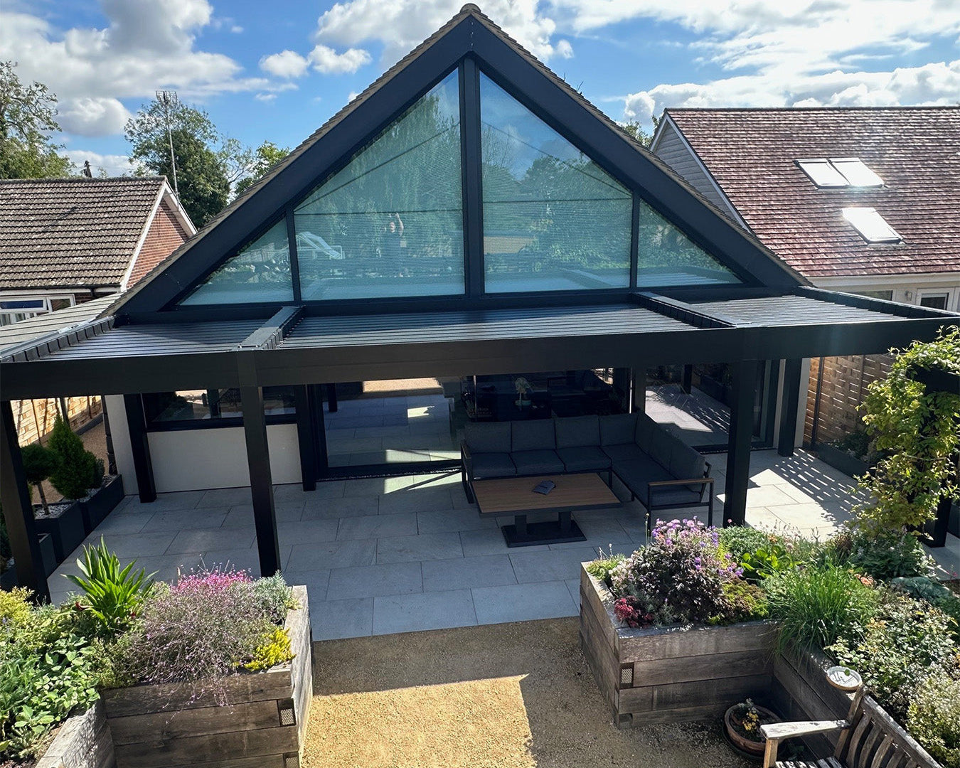 Modern luxury pergola with louvered roof and aluminium frame over outdoor seating area